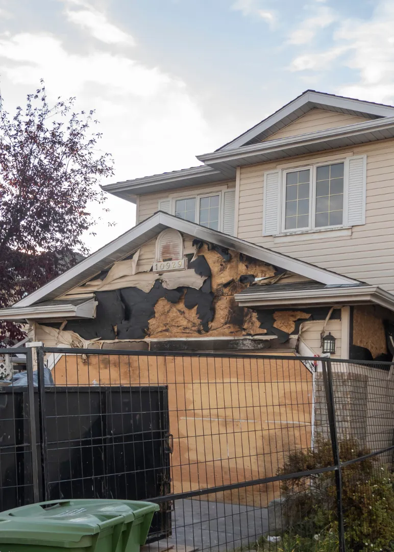 Fire damage restoration service in Dallas TX repairing exterior structural damage to a residential home after a fire
