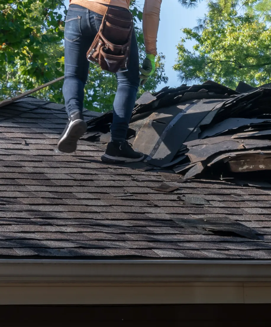 Storm damage roof repair in Dallas after hail and high winds, showing emergency restoration and roofing recovery services