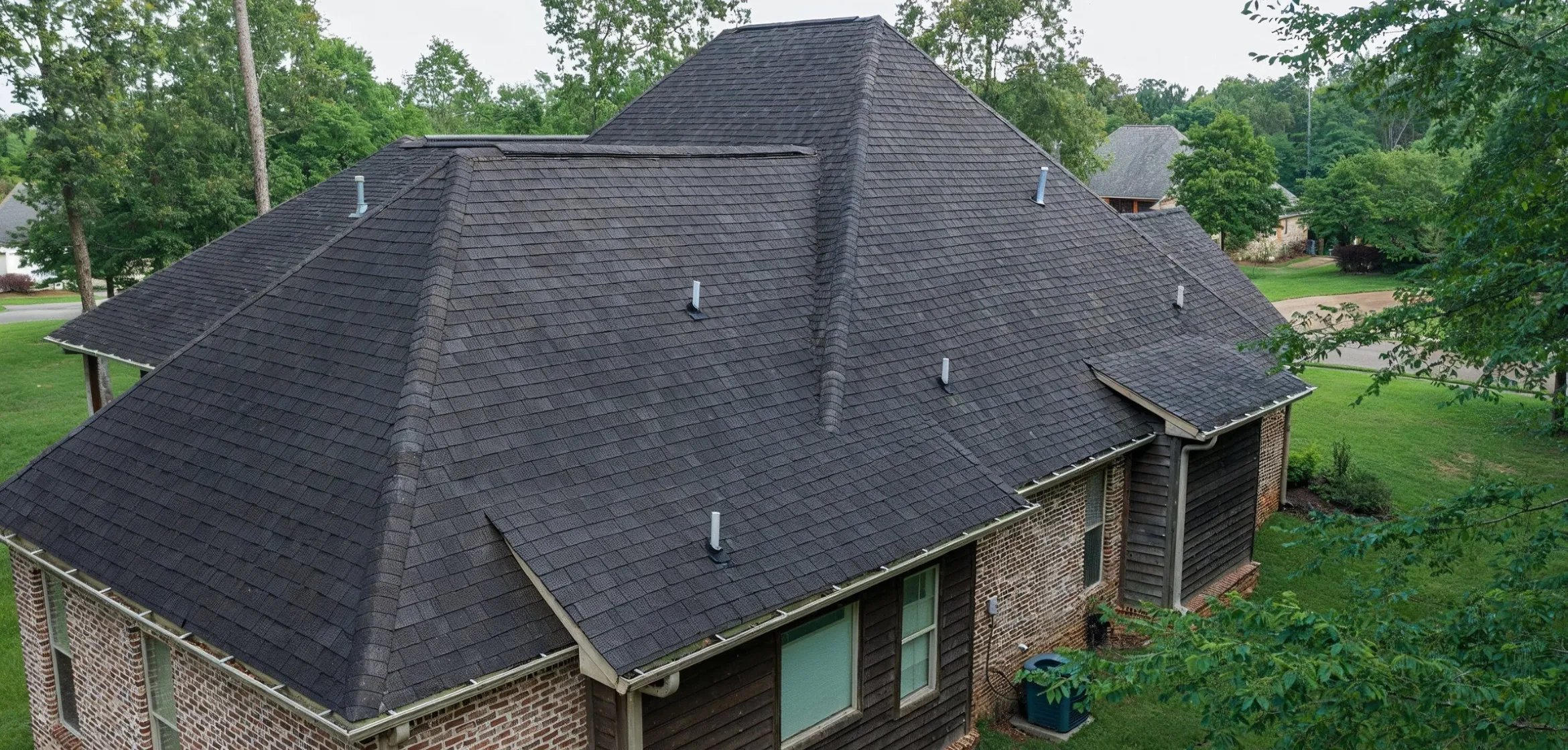 Restored asphalt shingle roof after storm and hail damage repair in Dallas
