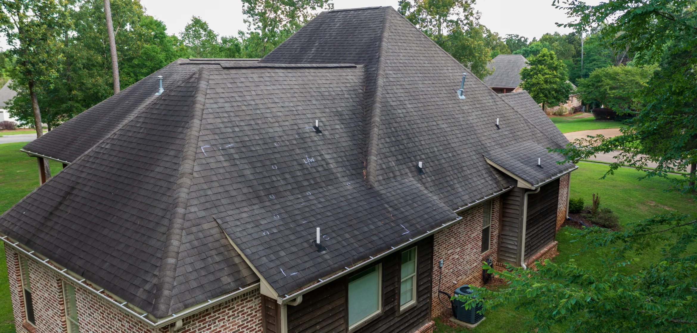 Storm and hail damaged roof on Dallas residential home before restoration