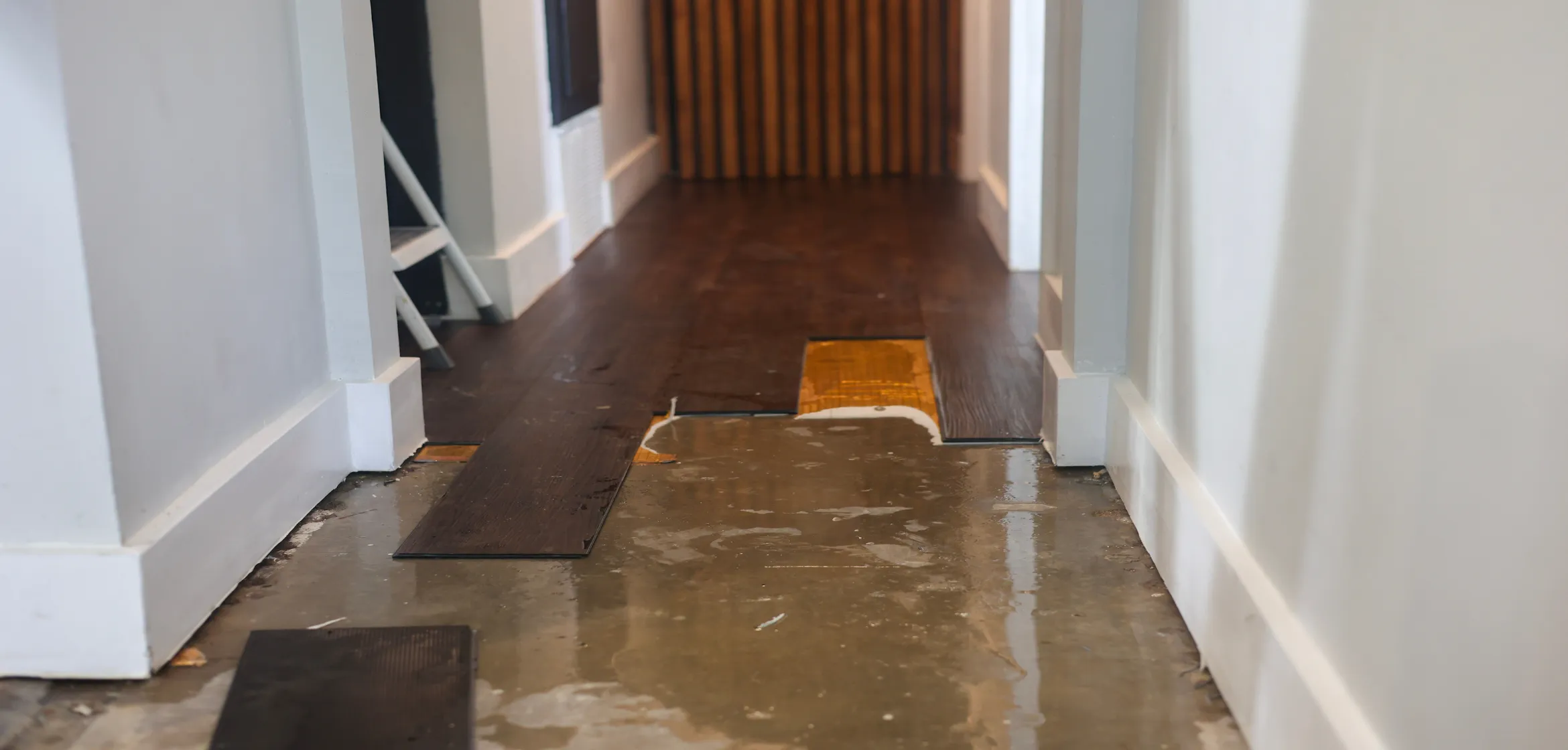 Water damage restoration in progress with wet flooring removed during emergency cleanup in Dallas