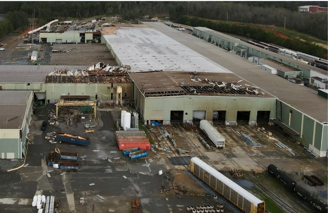 Wide aerial view of a commercial property undergoing large-scale disaster recovery and restoration.