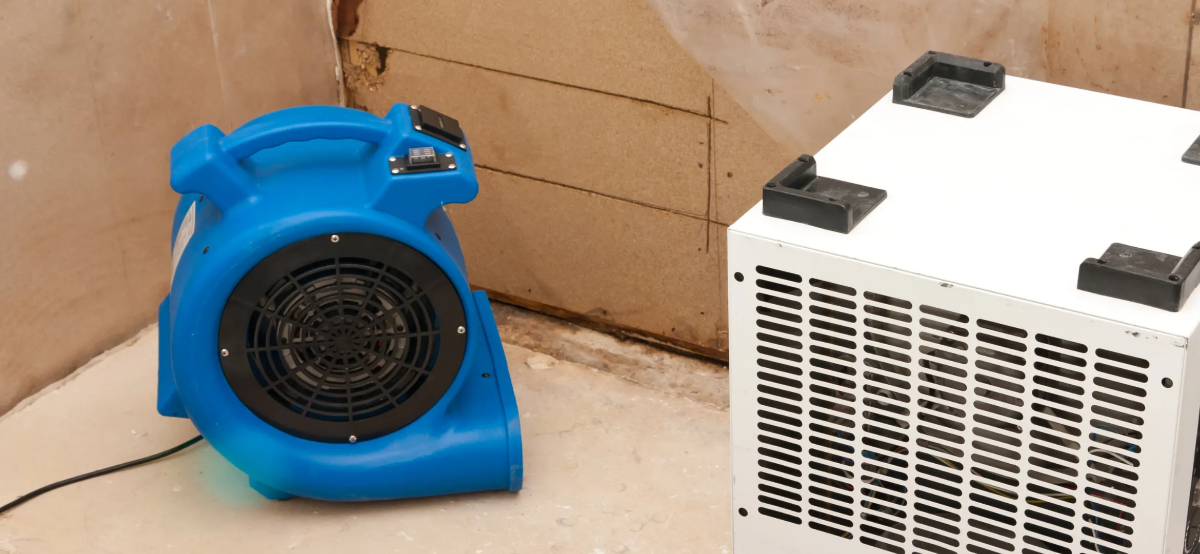 Commercial dehumidifier and air mover equipment used during water damage restoration process